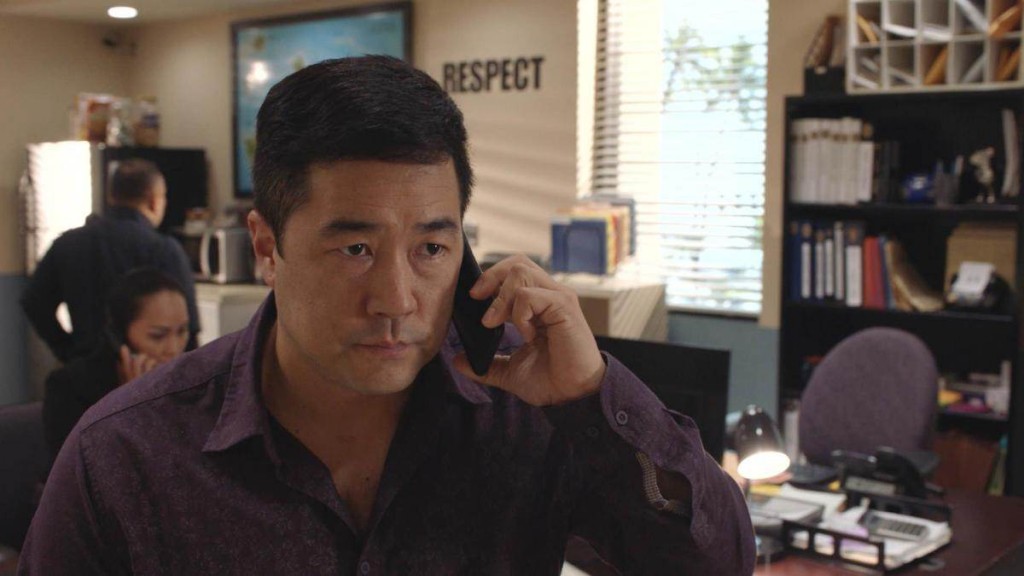 Le Lieutenant Gordon Katsumoto (Tim Kang) en pleine conversation téléphonique.